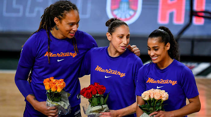 Brittney Griner, Diana Taurasi, and Skylar Diggins-Smith holding flowers